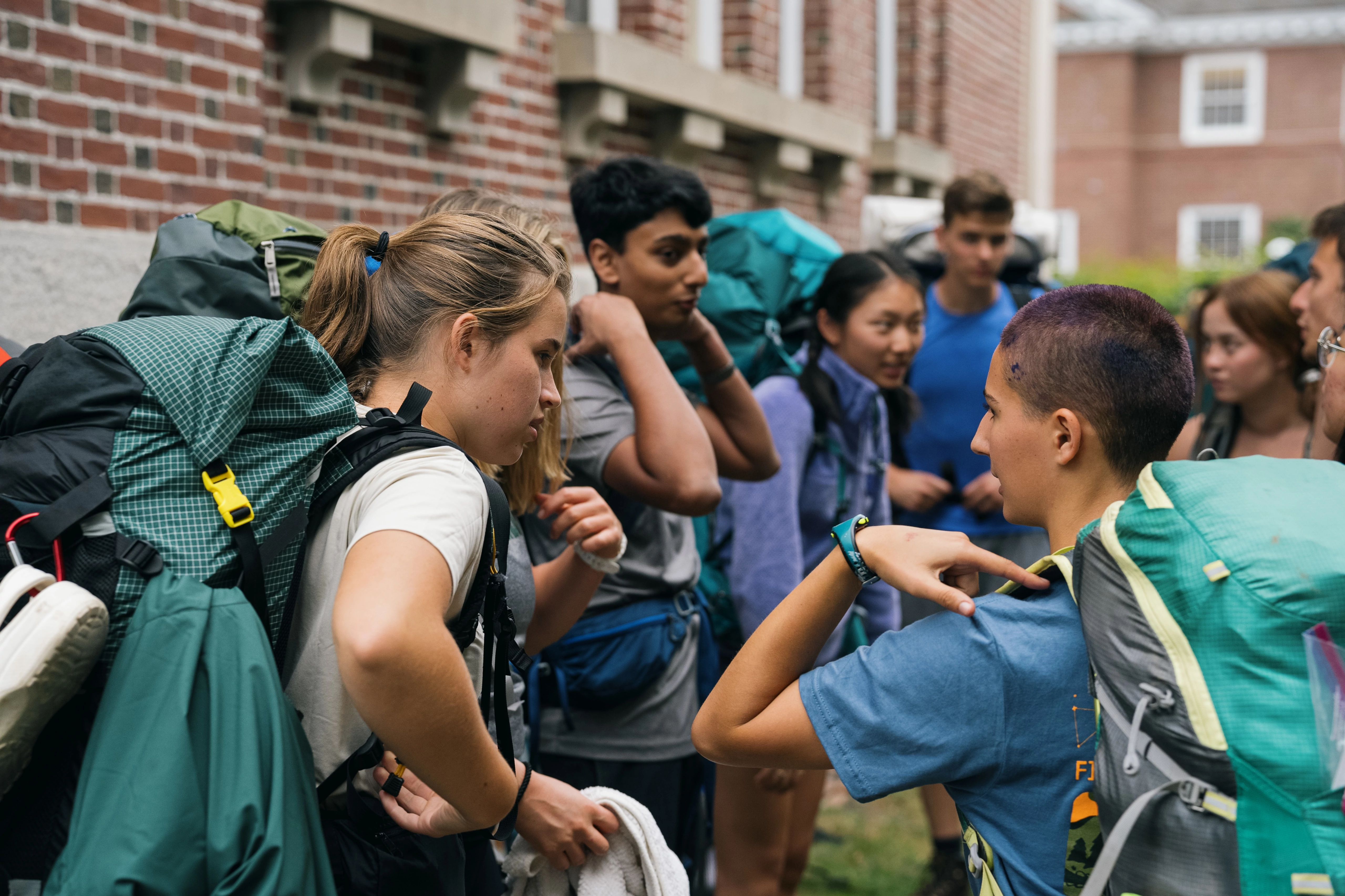 Students gather on campus for a first-year trip. 