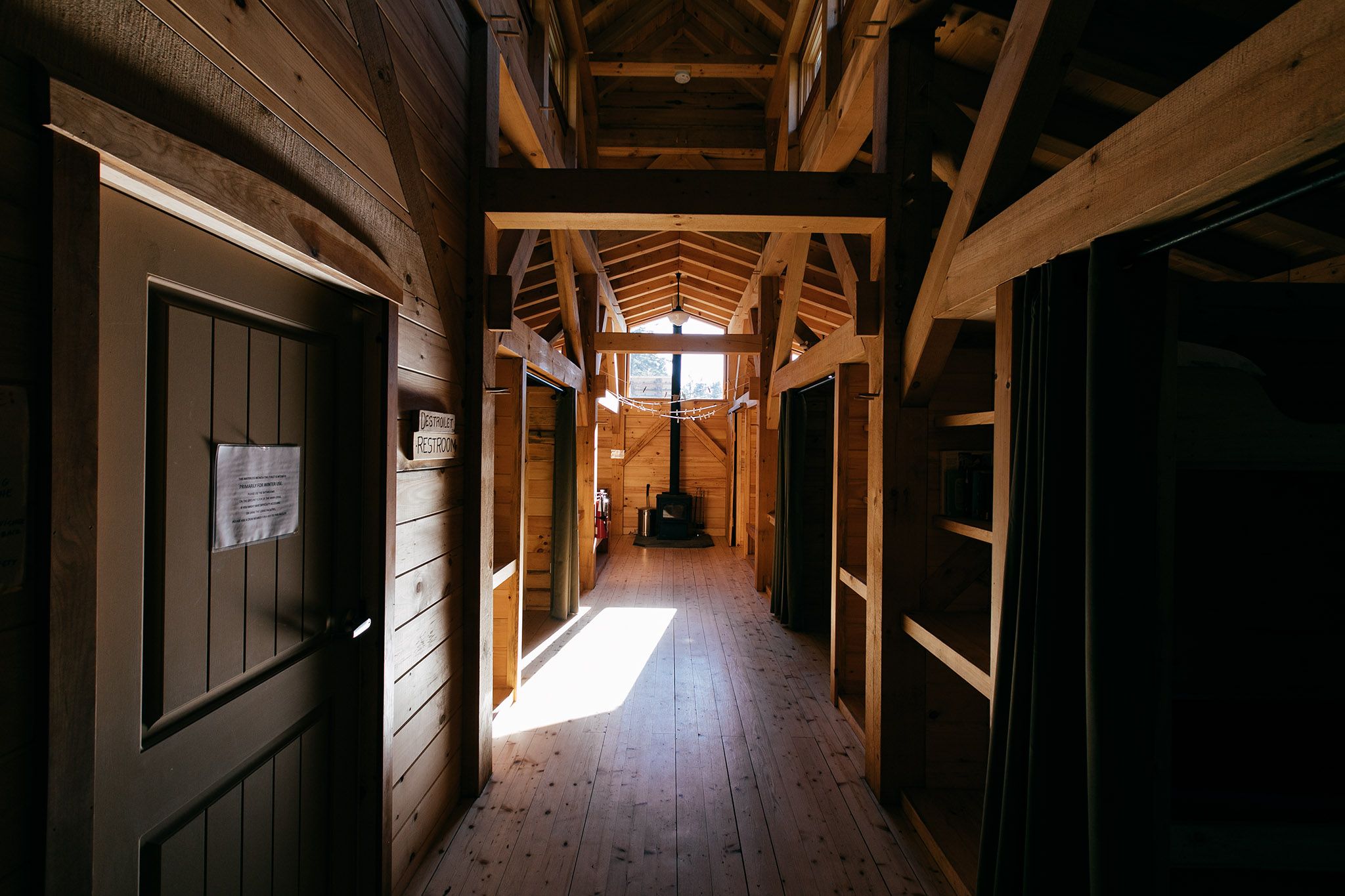 Image of bunkhouse interior, mostly dark.