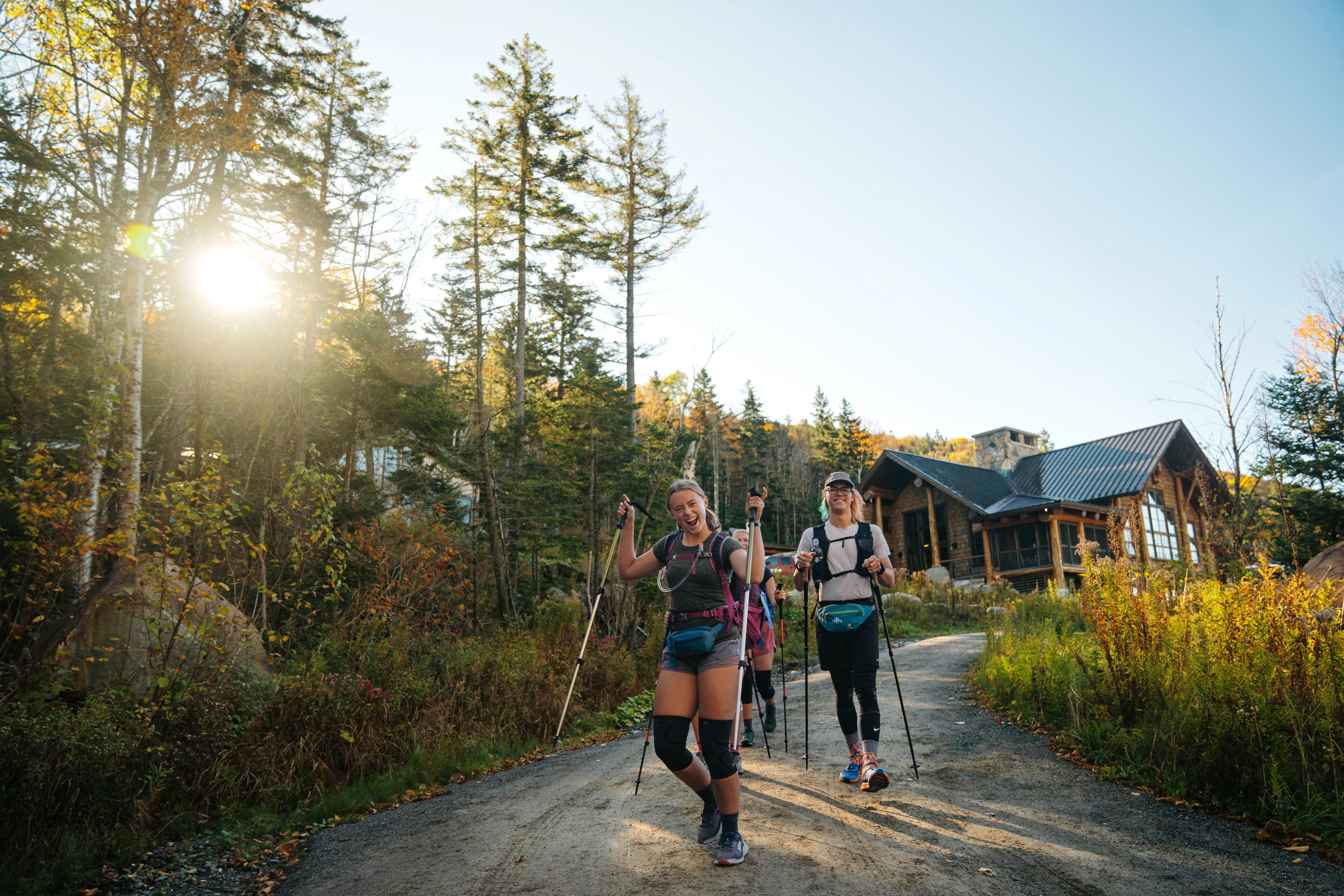 4 hikers seen walking away from the Moosilauke Ravine Lodge in fall foliage