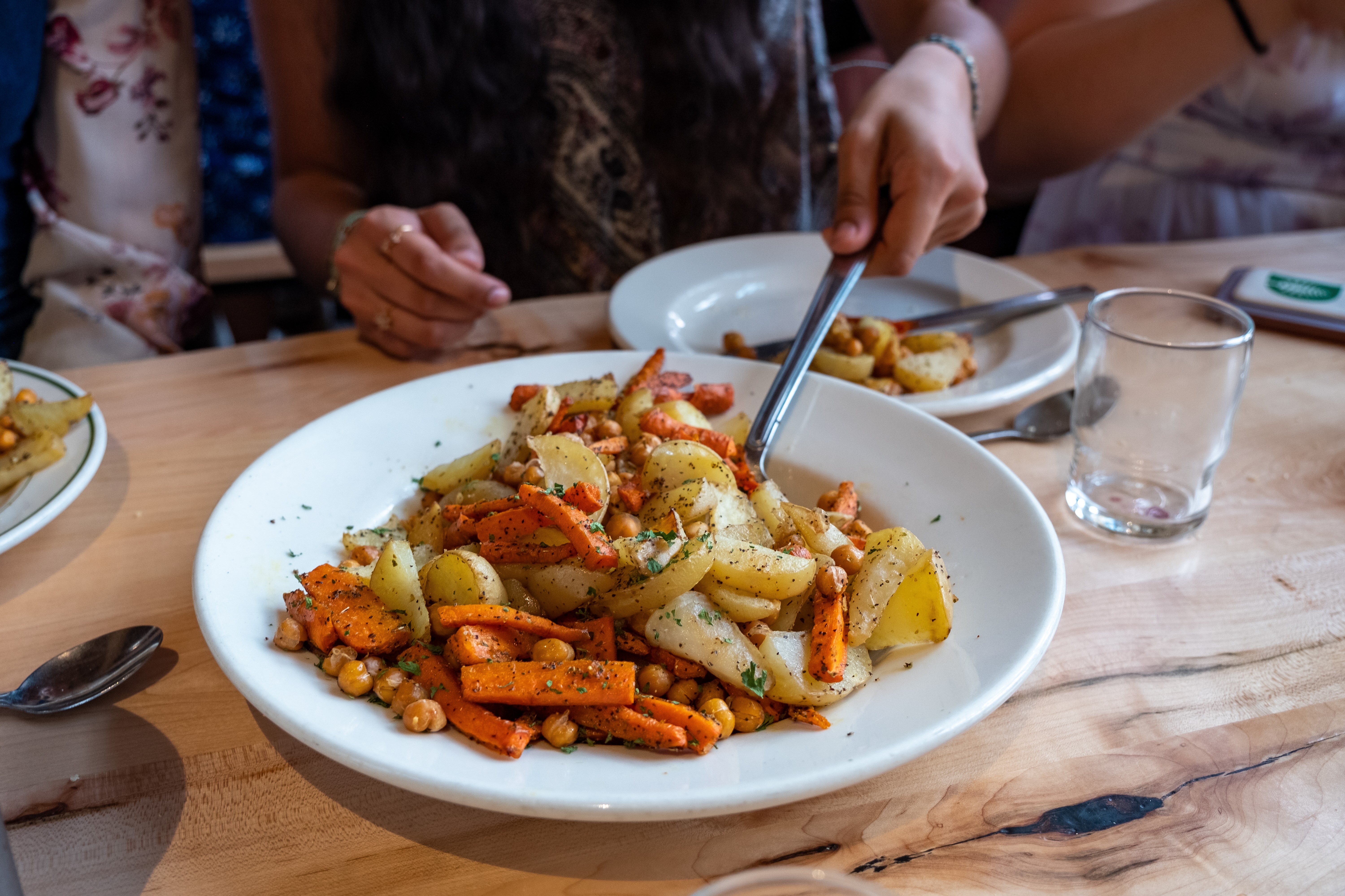 Roasted vegetables being served family style